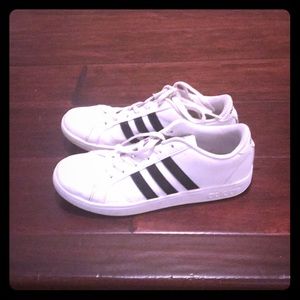 Girls white adidas sneakers with black stripes